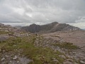 
	Looking south from the saddle, across upper Coire Lair.  The
	large, flat, sandstone slabs, and gravelly steps, are
	quite typical of this part - easy on the feet!
	