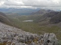 
    	    Looking down Coire Lair:  rightmost is the south end of Sgorr
	    Ruadh:  behind it Fuar Tholl.  Following the Allt Lair down from
	    Loch Coire Lair (large loch centre left, after which the Allt
	    becomes a river!), it bends to the right
	    before disappearing towards Loch Dughaill (just visible beyond).
	    It was nice to renew acquaintance with the scree-cat after our
	    walk up Coire Lair the previous year:  it's the light patch
	    beyond and to the right of the furthest visible part of
	    the Allt.
	    