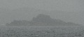 
	   Skerry looming out of the rain
	