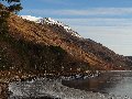 The sun highlighted the summit of Mullach an Rathain (here seen as a small pyramid on left high skyline, with a tor at its bottom left)