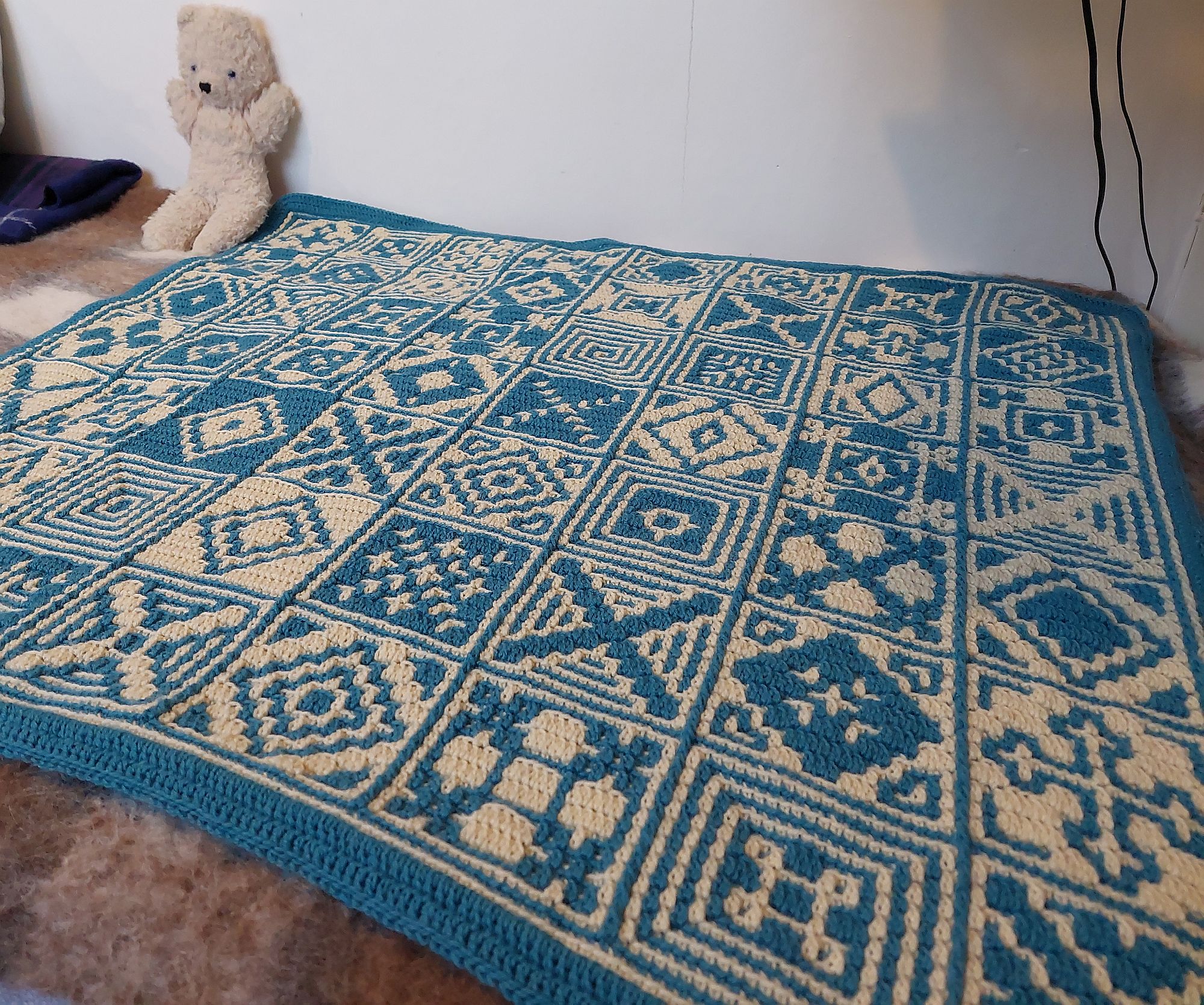 The finished blanket spread out on the bed. The finished blanket spread out on the bed.