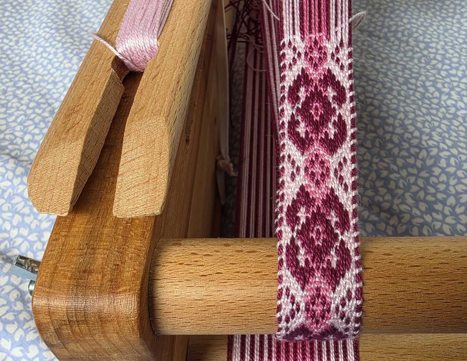 Pink pick-up band. Pink pattern threads and warp, pale pink weft. Pink pick-up band. Pink pattern threads and warp, pale pink weft.