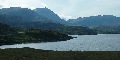 The east end of Loch Assynt:  on the skyline is
		Breabag Tarsuinn (right) and Conival (with steep right-hand
		side left of centre)